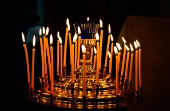 божі привітання з днем народження — A captivating display of lit candles on a golden holder, creating a warm and festive ambiance. | ITmaxService